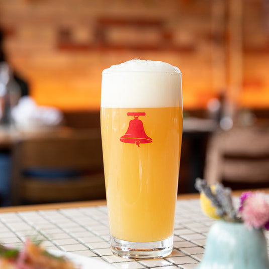 A pint of Bellwoods beer on the brewpub bar