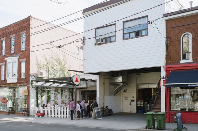 The original Bellwoods brewery on Ossington Avenue, behind its white picket fence
